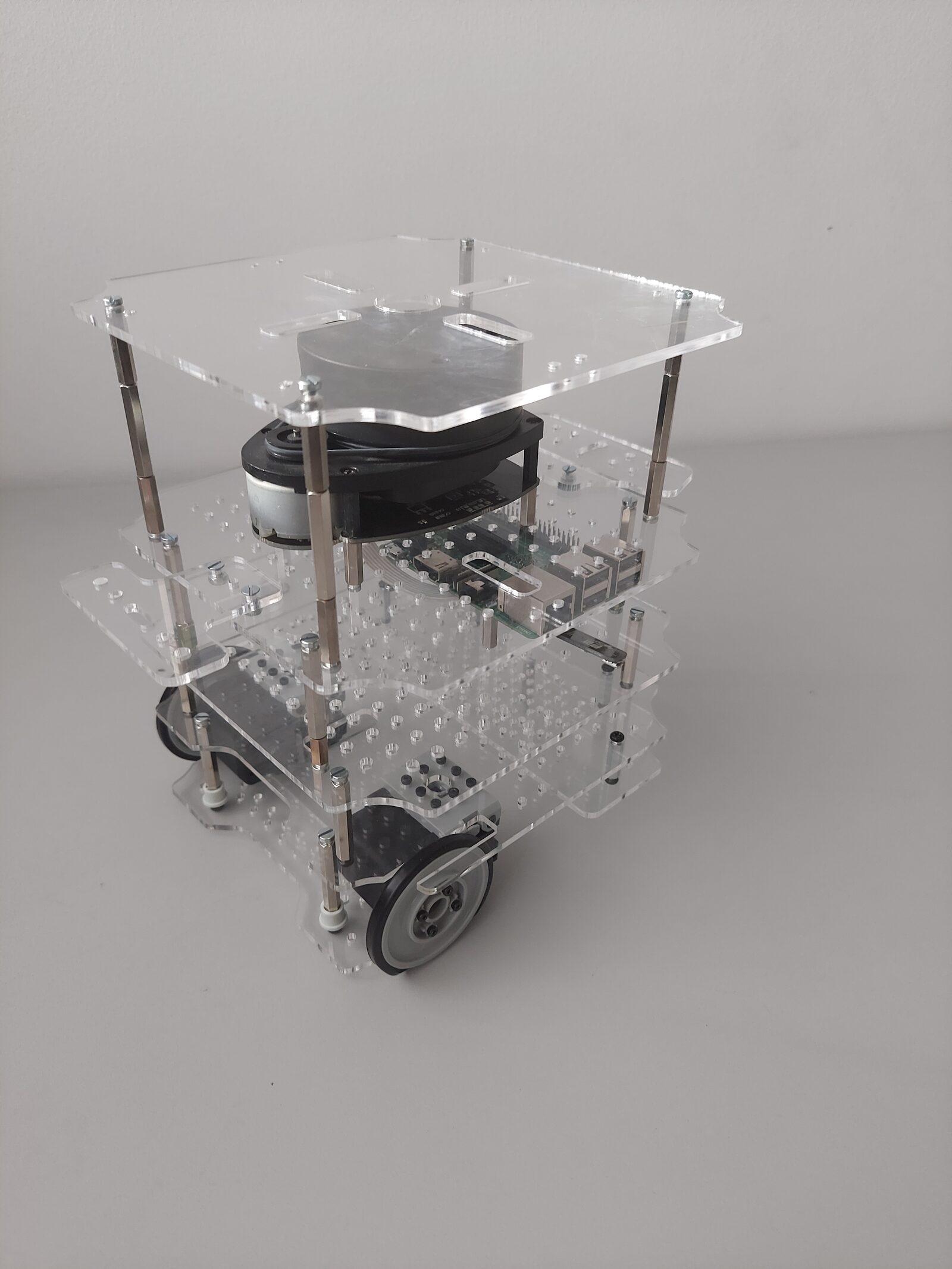 The Ratbot mobile robot: a transparent layered chassis carrying an on-board computer, motors and wheels.